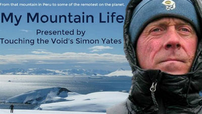 A close up of Simon Yates against a background of snowy mountains. 
