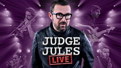 DJ Judge Jules against a purple background. 