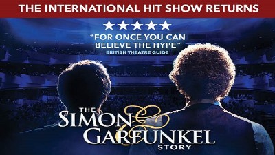 The acst of Simon and Garfunkel Story from the back as they face a blue lit audiennce. 
