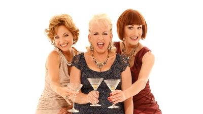 A close up of three actresses holding martini glasses. 