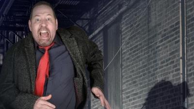 A close up of comedian Alfie Moore running. 