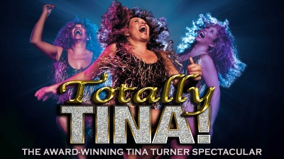 Justine Riddoch as Tina Turner against a dark background with text reading 'Totally Tina'