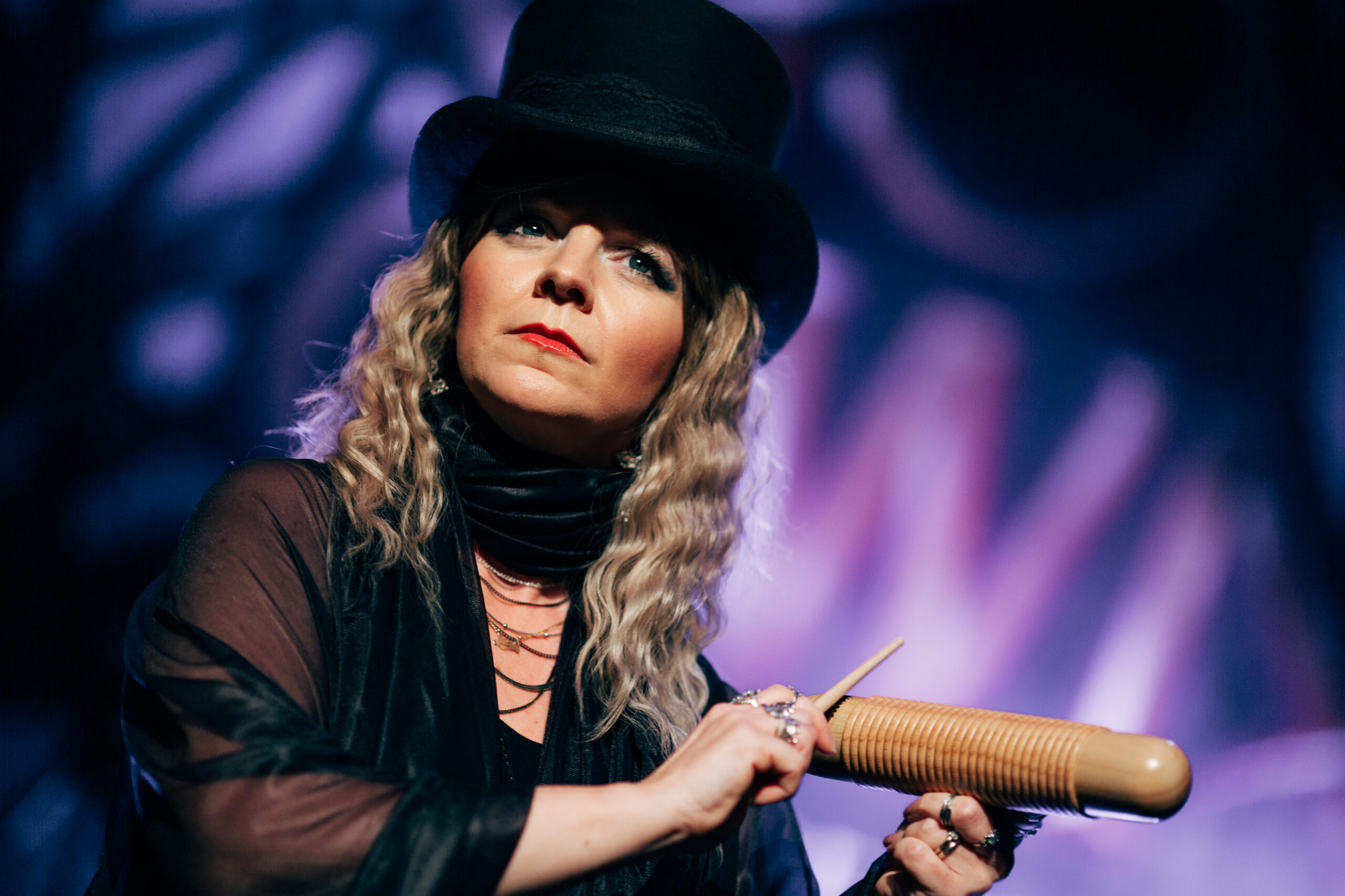 A member of The Fleetwood Mac Legacy plays a wooden guiro. 